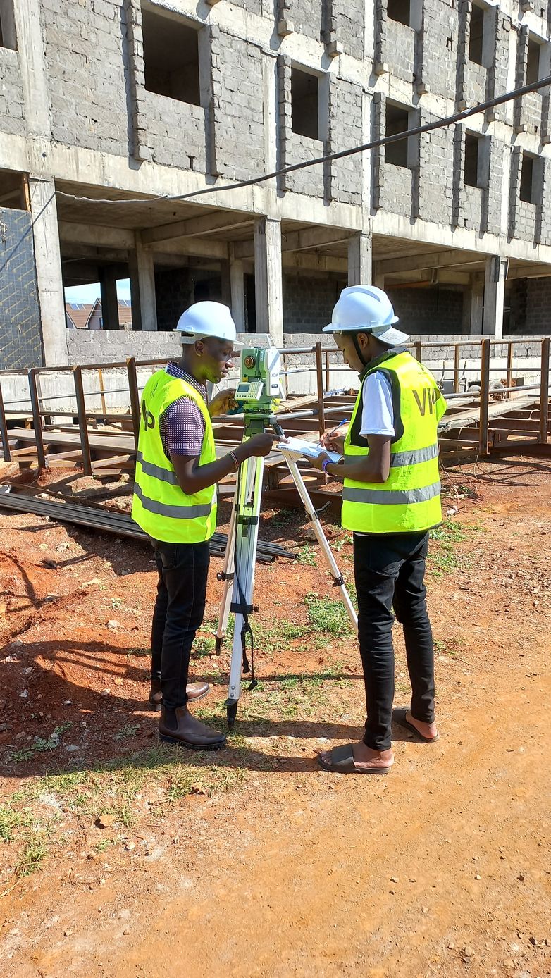 Two surveyors reviewing data at a construction site
